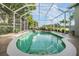 Refreshing screened-in pool with hot tub offers a relaxing space to cool off and enjoy the view at 2216 Eagle Bluff Dr, Valrico, FL 33596
