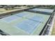 Overhead view of well-maintained green and blue tennis courts, providing a great amenity for residents to enjoy at 2216 Eagle Bluff Dr, Valrico, FL 33596