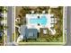 A birds eye aerial view of the community center and pool with lounge seating at 2401 Morninglight Dr, Lutz, FL 33558