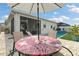 A cozy backyard with a patio table, outdoor furniture and pool beyond at 2401 Morninglight Dr, Lutz, FL 33558
