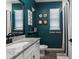 Unique bathroom design with a black vanity, modern fixtures, and sports-themed decor at 2401 Morninglight Dr, Lutz, FL 33558