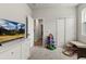 Bedroom with neutral colors, a large dresser with a TV, and toys at 2401 Morninglight Dr, Lutz, FL 33558