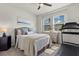 Serene bedroom with a ceiling fan, large windows, comfortable bed, and a modern treadmill at 2401 Morninglight Dr, Lutz, FL 33558