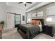 Bedroom featuring a dark wood bed frame, neutral walls, and a modern barn door at 2401 Morninglight Dr, Lutz, FL 33558