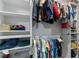 Walk-in closet with organized shelving and hanging racks, containing a variety of clothing and accessories at 2401 Morninglight Dr, Lutz, FL 33558