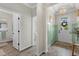 Stylish foyer featuring wood-look tile flooring, wainscoting, chandelier, and views into the home at 2401 Morninglight Dr, Lutz, FL 33558