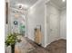 Well-lit entryway with wood-look flooring, modern decor, and views into the home at 2401 Morninglight Dr, Lutz, FL 33558