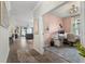 Open floor plan showcasing a home office with a pink accent wall and stylish furnishings at 2401 Morninglight Dr, Lutz, FL 33558