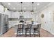 Stylish kitchen with white cabinets, stainless steel appliances, and a large island with bar stool seating at 2401 Morninglight Dr, Lutz, FL 33558