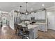 Spacious kitchen featuring a large island with seating, stainless steel appliances, and stylish pendant lighting at 2401 Morninglight Dr, Lutz, FL 33558