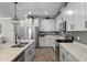Modern kitchen with white cabinets, stainless steel appliances, granite countertops, and wood-look flooring at 2401 Morninglight Dr, Lutz, FL 33558