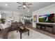 Open-concept living room with a view of the kitchen, complete with modern furnishings and decor at 2401 Morninglight Dr, Lutz, FL 33558