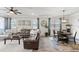 Inviting living room featuring a comfortable leather sectional, wood floors, and stylish decor at 2401 Morninglight Dr, Lutz, FL 33558