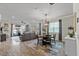 Open-concept living room with wood floors, modern furnishings, and sliding glass doors to outdoor area at 2401 Morninglight Dr, Lutz, FL 33558