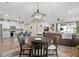 Open concept living area featuring a dining table, kitchen island, and comfortable seating at 2401 Morninglight Dr, Lutz, FL 33558