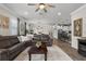 Spacious living room featuring a large leather sofa, wood floors, and an open layout to the kitchen at 2401 Morninglight Dr, Lutz, FL 33558