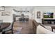 Open-concept living area with kitchen island, dining table, and comfortable seating at 2401 Morninglight Dr, Lutz, FL 33558