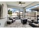 Relaxing screened patio area featuring a ceiling fan, comfortable seating, and a view of the backyard at 2401 Morninglight Dr, Lutz, FL 33558