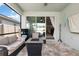 This is an inviting patio with cozy seating, a modern fire pit, and seamless indoor-outdoor living at 2401 Morninglight Dr, Lutz, FL 33558