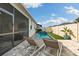 A private pool and backyard featuring lounge chairs and a well-maintained lawn, perfect for outdoor enjoyment at 2401 Morninglight Dr, Lutz, FL 33558