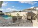 Backyard oasis with a sparkling pool, comfortable seating, and lush landscaping for ultimate relaxation at 2401 Morninglight Dr, Lutz, FL 33558