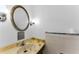 Bathroom featuring an oval mirror, updated lighting, and classic fixtures at 2700 Bayshore Blvd # 2110, Dunedin, FL 34698
