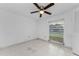 Bright bedroom with ceiling fan, neutral walls and tiled floor at 2700 Bayshore Blvd # 2110, Dunedin, FL 34698