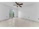 Bedroom featuring tile floors, ceiling fan, and natural light from the window at 2700 Bayshore Blvd # 2110, Dunedin, FL 34698