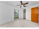 Bedroom with neutral walls, ceiling fan, tiled floor, and closet at 2700 Bayshore Blvd # 2110, Dunedin, FL 34698