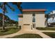 Exterior view of a building with a red roof, featuring a garage and easy access entrance at 2700 Bayshore Blvd # 2110, Dunedin, FL 34698