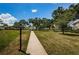 Scenic walkway through the community grounds surrounded by mature trees and green space at 2700 Bayshore Blvd # 2110, Dunedin, FL 34698