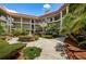 Beautiful courtyard with water feature, lush landscaping, and seating areas at 2700 Bayshore Blvd # 2110, Dunedin, FL 34698