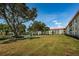 Beautiful exterior view of building with grassy lawn and mature trees at 2700 Bayshore Blvd # 2110, Dunedin, FL 34698