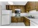 Traditional kitchen with wood cabinets, and white appliances at 2700 Bayshore Blvd # 2110, Dunedin, FL 34698