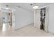 View of hallway leading to water heater closet, all with neutral tile flooring at 2700 Bayshore Blvd # 2110, Dunedin, FL 34698