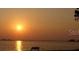 Beautiful sunset over the water with a bench in the foreground at 2700 Bayshore Blvd # 2110, Dunedin, FL 34698