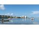Tranquil water view with boats, calm water, and nearby residences under a clear sky at 2700 Bayshore Blvd # 2110, Dunedin, FL 34698