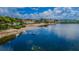 Scenic waterfront view featuring a sandy beach, calm water, and picturesque coastal residences at 2700 Bayshore Blvd # 2110, Dunedin, FL 34698