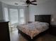 Bright bedroom with large windows, ceiling fan, and neutral decor at 2713 Via Murano # 210, Clearwater, FL 33764