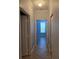Hallway with neutral paint, tile flooring, and white doors and trim at 2713 Via Murano # 210, Clearwater, FL 33764