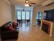 Cozy living room with fireplace, neutral tones, and dining area view at 2713 Via Murano # 210, Clearwater, FL 33764