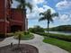 Paver walkway leading to a tranquil waterfront view near the building at 2713 Via Murano # 210, Clearwater, FL 33764