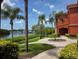 Picturesque waterfront view with palm trees and a community picnic area at 2713 Via Murano # 210, Clearwater, FL 33764