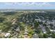 Breathtaking aerial view of a residential neighborhood featuring a mix of homes nestled amidst trees with stunning ocean views at 3011 Harbor View, Tampa, FL 33611