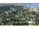 Sweeping aerial view of homes near the coastline with beautiful mature trees in a quiet neighborhood at 3011 Harbor View, Tampa, FL 33611