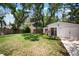 Spacious back yard with lush green lawn and mature trees, providing shade and privacy for outdoor enjoyment at 3011 Harbor View, Tampa, FL 33611