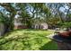 Well-manicured backyard with a detached garage and an outdoor seating area at 3011 Harbor View, Tampa, FL 33611