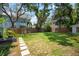 Spacious backyard with lush green grass and a stepping stone pathway at 3011 Harbor View, Tampa, FL 33611