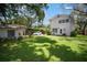 Expansive backyard view showcasing the home's exterior and a detached garage at 3011 Harbor View, Tampa, FL 33611