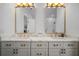 Modern bathroom featuring dual vanity with marble counters and gold accents at 3011 Harbor View, Tampa, FL 33611